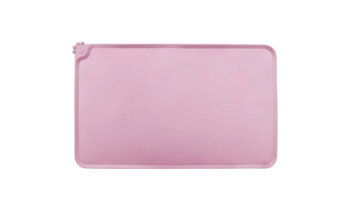 Waterproof silicone cat feeding mat in pink with raised edges to stop spills from reaching and damaging your floor.